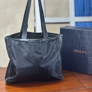 Chic black handbag by Prada. Ideal for versatile styling. AUTHENTIC.